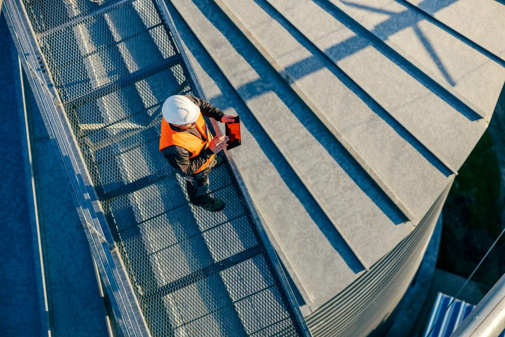 Technician conducting a commercial roof inspection 